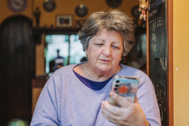 istock Senior woman making a video call on smartphone at home 2070290498