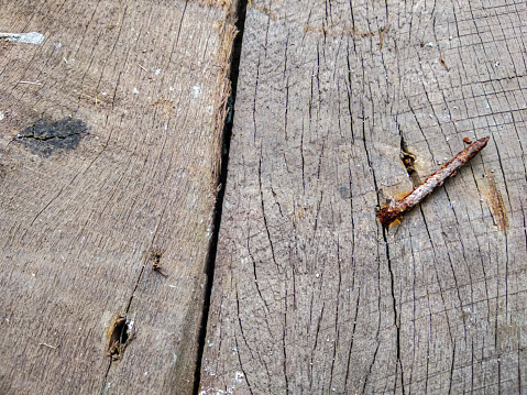 close-up view of old, rusty nails on a wooden board