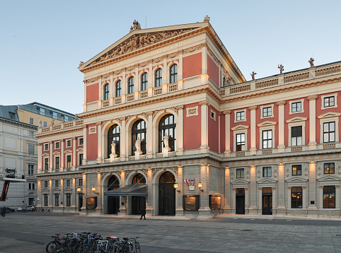 Vienna, Austria - June 13, 2013: Musikverein's front facade at dusk. Neoclassical concert hall in Vienna. The building in the historical style with columns, pediments and reliefs.