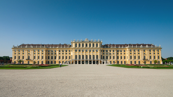 Vienna, Austria - June 17, 2013: Schönbrunn Palace - main facade. View from Palace Park at a huge yellow baroque-styled 18th century palace.