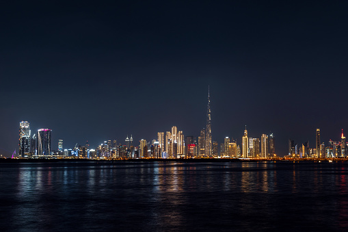 view of Dubai downtown cityline from Dubai creek canal at night