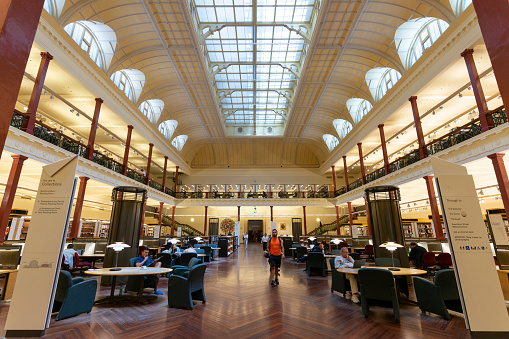 Sydney, Australia - December 30, 2019: The interior of State Library of New South Wales. State library of NSW with students and people studying and reading. The State Library of NSW is a large reference and research library open to the public. It is the oldest library in Australia.