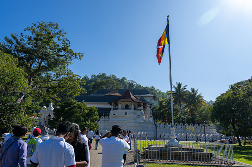 Kandy, Sri Lanka - January 24, 2024: Tourists flock outside Sri Dalada Maligawa, known as the Temple of the Sacred Tooth Relic, in Kandy, Sri Lanka.