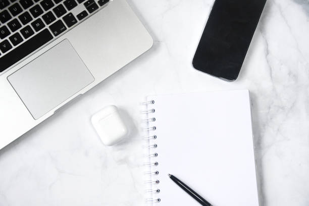 istock Overhead of laptop computer, phone and notebook 2070406224