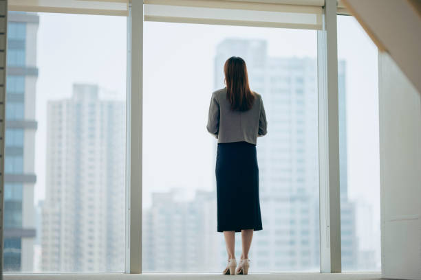 istock Business woman looking out window 2070411428
