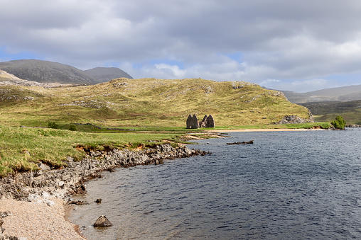 The ruins of Calda House, set against the stunning backdrop of the Scottish Highlands, offer a glimpse into Scotland's storied past. Surrounded by rugged hills, the serene waters of the lake reflect the ever-changing skies