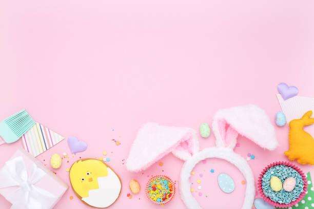 istock Easter gingerbread cookies with gift box, rabbit ears and sprinkles on pink background 2070534892