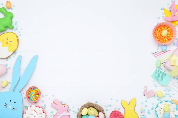 istock Easter concept. Cookies with colorful eggs, marshmallows and sprinkles on white wooden table 2070535906