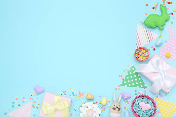istock Easter concept. Paper flags white gift boxes, eggs and sprinkles on blue background 2070536934