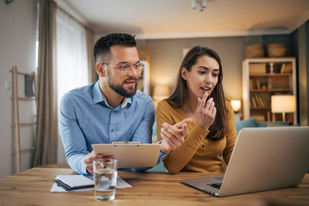 istock Busy couple working with finance in dining room 2070543706