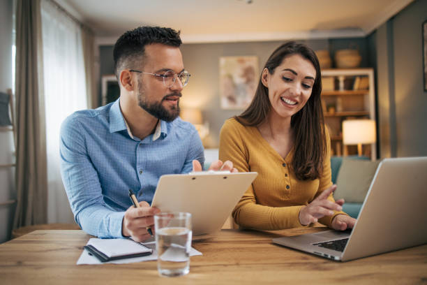 istock Busy couple working with finance in dining room 2070544735