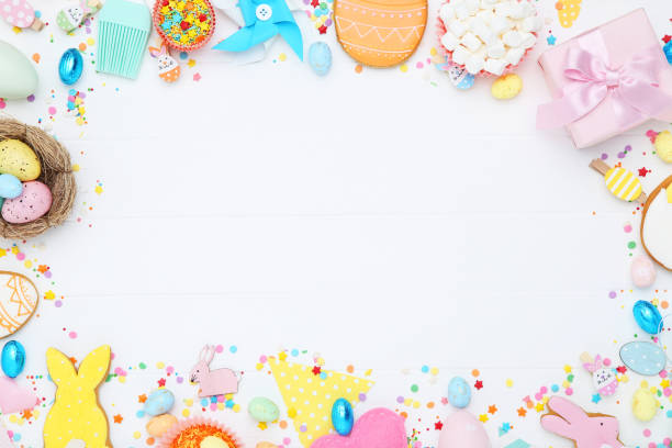 istock Easter gingerbread cookies with candies and gift box on white wooden table 2070546328