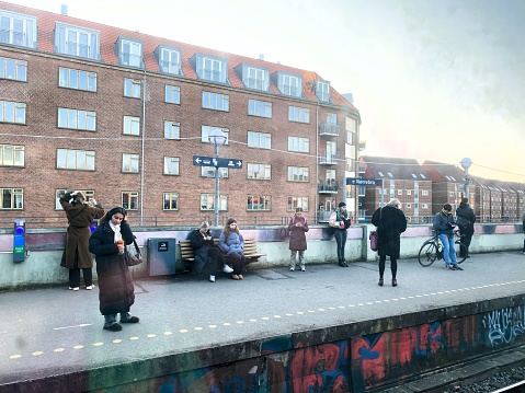 The photo was taken within an S-train at Nørreport Station, Copenhagen, Denmark, on March 6 2024. An apartment building can be seen in the background.