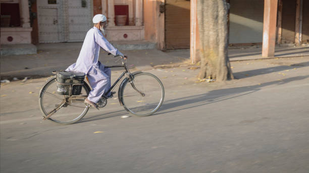 istock Indian man rides a bicycle, India 2070601910