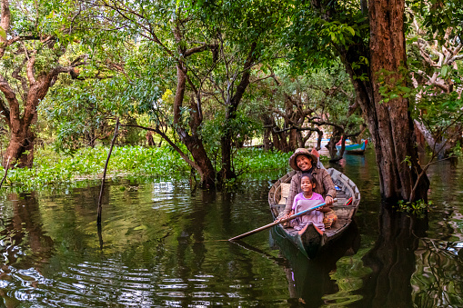 Cambodian mother with her daughter in a boat on Tonle Sap, Cambodia