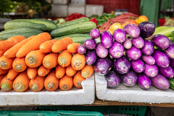 Carrots and eggplants for sale at a market stall. The photograph is taken at the Chow Kit market in the Malaysian capital Kuala Lumpur