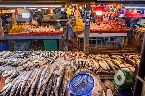 Chow Kit market, Kuala Lumpur, Malaysia - January 10th 2024: Rear view to a fishmongers stall in the famous food market in the center of the capital
