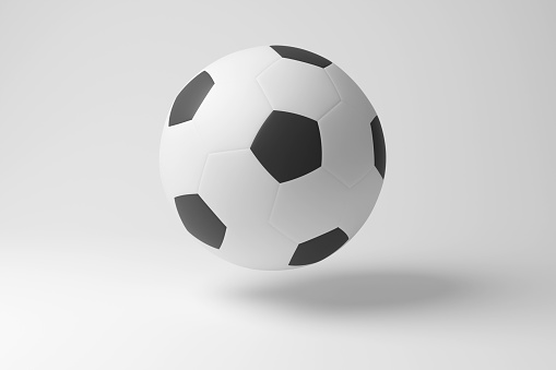 White soccer ball floating in mid air in white background in monochrome and minimalism. Illustration of the concept of team sports and football tournaments