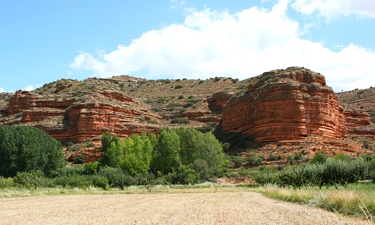 Red mountain with different stratas of earth due to erosion caused by water and wind