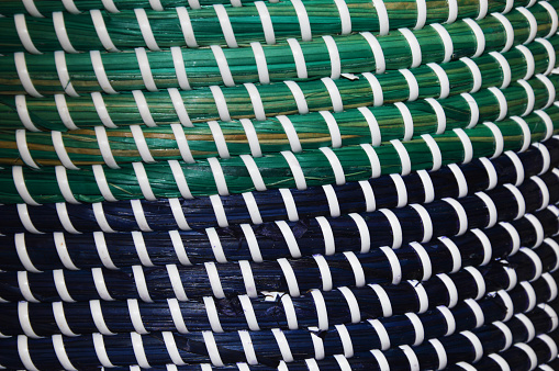 Green and white plastic weave texture pattern. texture of rattan mats, baskets or furniture. Abstract weave pattern background.