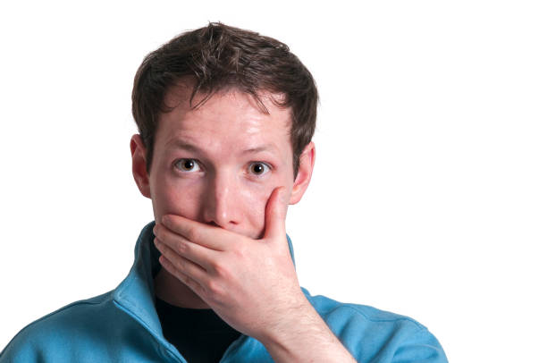 istock Man covers his mouth in shock on white 2070674989