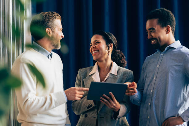 istock Diverse Business Team Engaging in a Casual Discussion with a Tablet 2070679187