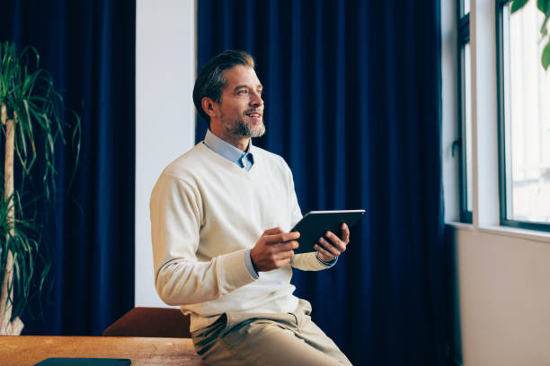 Confident Businessman with Tablet in a Modern Office Space