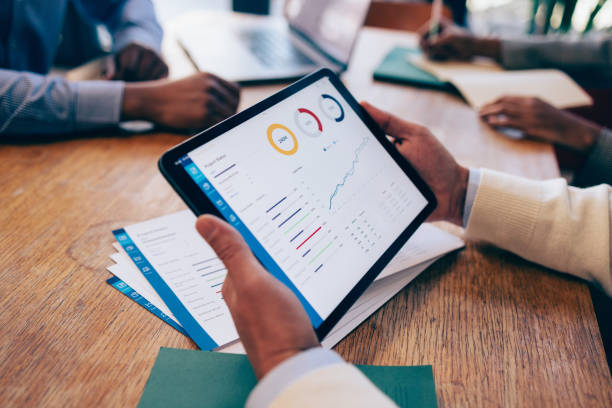 istock Business Professionals Analyzing Financial Statistics on Tablet 2070679218