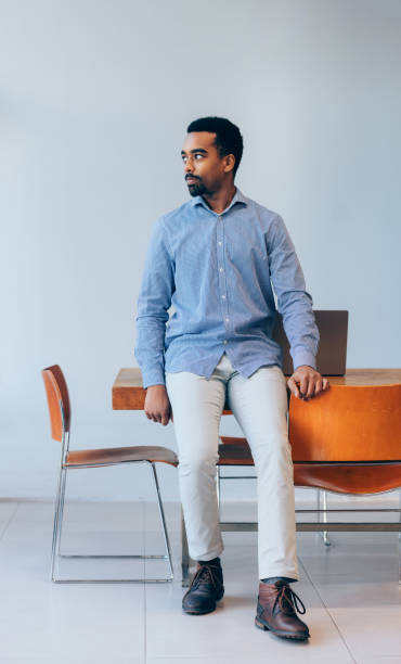 istock Confident Young Man Sitting on Chair in Modern Office Setting 2070679732