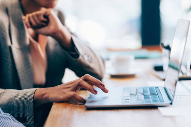 istock Focused Businesswoman Using Laptop for Business Tasks at a Cafe 2070679733