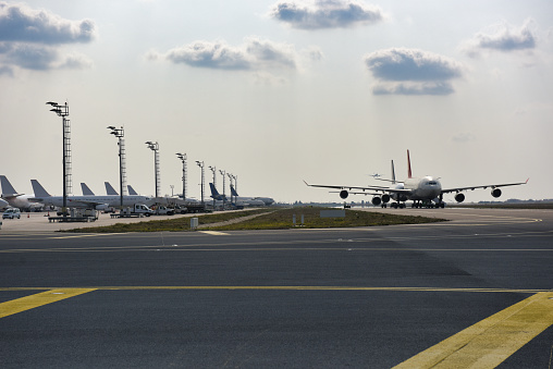 Istanbul, Turkey - June 3, 2023: Turkish Airlines airplane with Air Traffic Control Tower of Istanbul Airport. View of international Istanbul New Airport.