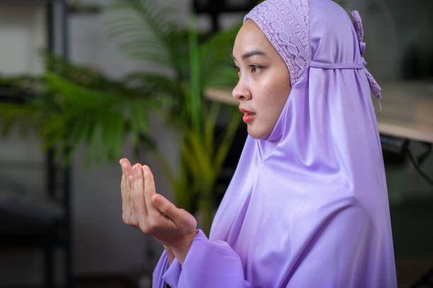 istock Asian Muslim woman prays inside her home during Ramadan 2070689174