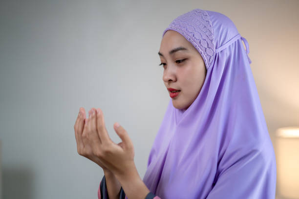 istock Asian Muslim woman prays inside her home during Ramadan 2070689192