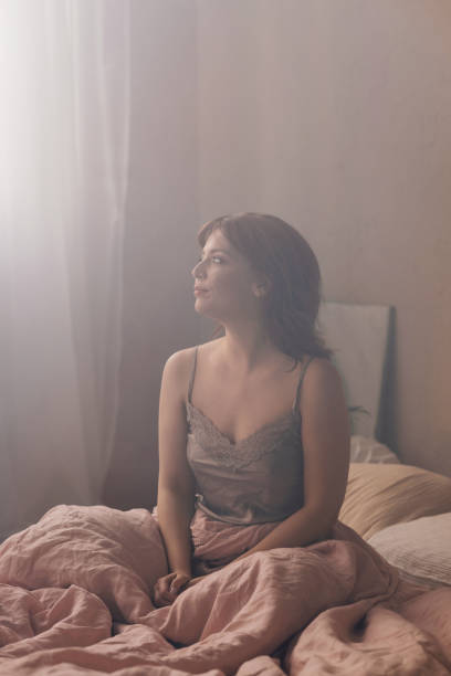 istock Serene Woman in Bed Basking in Soft Morning Light 2070690227