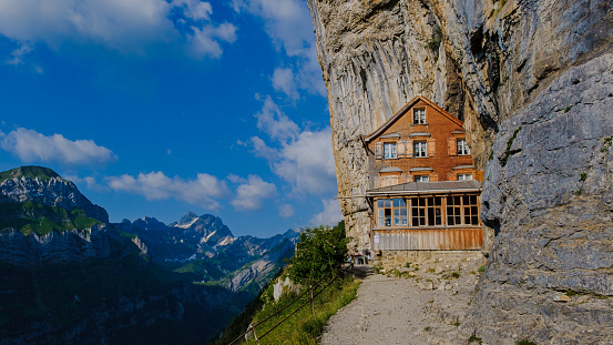 Berggasthaus Aescher in den Appenzeller Alpen at sunset, restaurant under a cliff on mountain Ebenalp in Switzerland, Appenzell