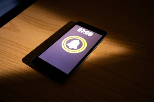 istock Smartphone alarm clock app rings for wake up 2070717550