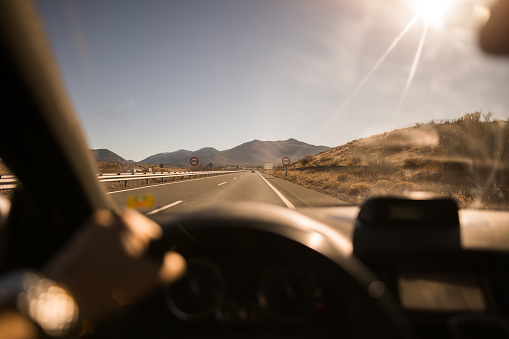 First person view of driving a car on a highway in south of Spain on a sunny day.