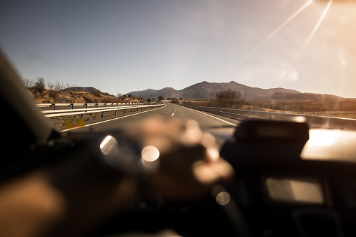 First person view of driving a car on a highway in south of Spain on a sunny day.