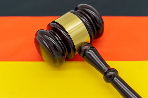 Legal authority in Germany represented by a gavel on the German flag.