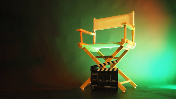 istock Director chair and black clapper board in green light. 2070749939