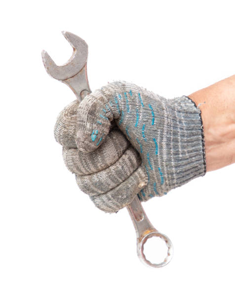 istock Hands in work gloves holding a wrench, isolated on white background 2070787920