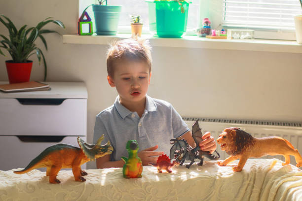 istock boy in a bright room playing with toys 2070789484