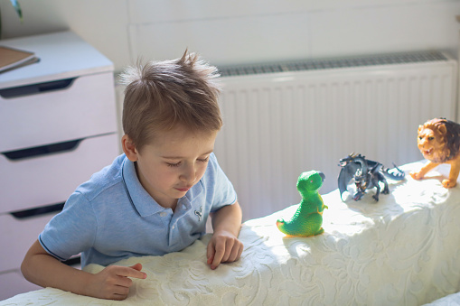 boy in a bright room playing with toys