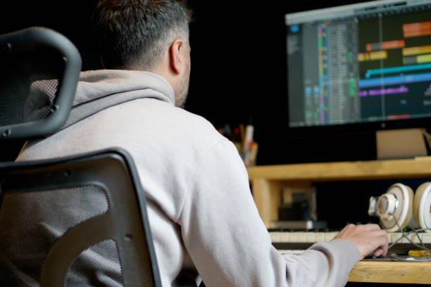 istock Side view of concentrated sound producer working at studio 2070791106