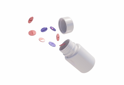 Pills coming out of a plastic bottle