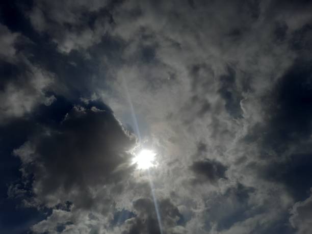 istock The sun appears from behind white and gray clouds on a winter day 2070846114