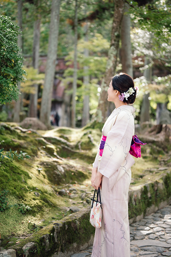 Asian Gen-Z wear kimono traditional japanese coutume travel in public japan park in kyoto japan