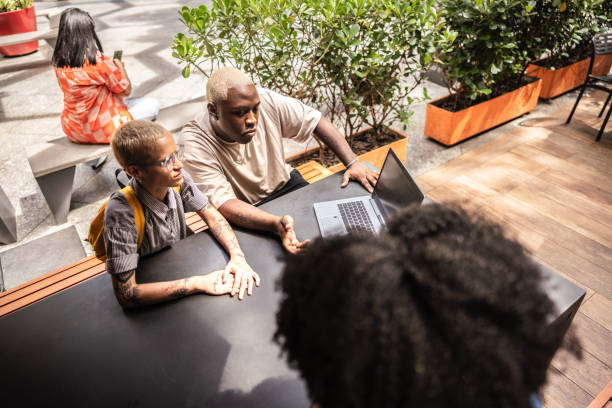 istock LGBTQQICAAPF2K+ students using laptop studying outdoors 2070898944