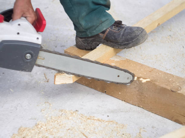istock Worker sawing a wooden plank with a chainsaw 2070900011