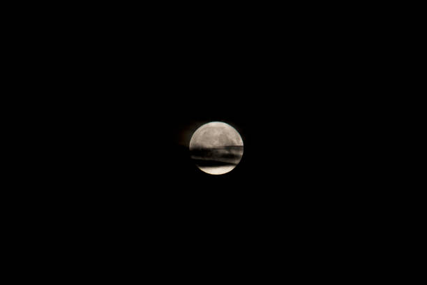 Full moon breaking through dark clouds